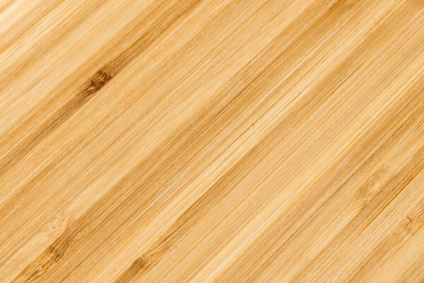 Close-up of bamboo wood texture with natural grain and warm tones, ideal for backgrounds.